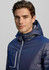 A navy unisex patrol jacket featuring a hood and zippered pockets, with a logo on the chest.