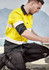 Men's long sleeve shirt in yellow with reflective tape, featuring a black bottom section. Logo present on the shirt.