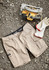 Mens Essential Stretch Cargo Shorts in beige, laid out on gravel, alongside a power tool and gloves. Features branding.