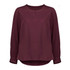 A burgundy long sleeve blouse with a round neckline and button detail, featuring gathered sleeves and a flowing silhouette.