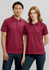 A burgundy women's short sleeve polo shirt with a collar, featuring a logo, styled on a model.