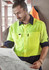 A high-visibility long sleeve shirt in fluorescent yellow and navy, featuring multiple pockets and a logo.