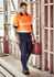 A man wearing an orange long sleeve segmented tape work shirt and navy pants, holding a red toolbox in a construction setting.
