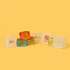 Jelly Cube sensory toys in various colours, featuring a promotional logo on one cube against a bright yellow background.