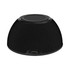 A black wireless charging speaker with a textured surface and a USB-C port at the base.