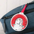 A curled red Type-C charge cable kit housed in a clear case, attached to a blue bag.