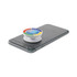 A white pocket socket phone stand is attached to a grey smartphone, featuring a multicoloured design on top.