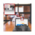A webcam cover slide in white positioned on a laptop, with a blurred background of a woman working at a desk.