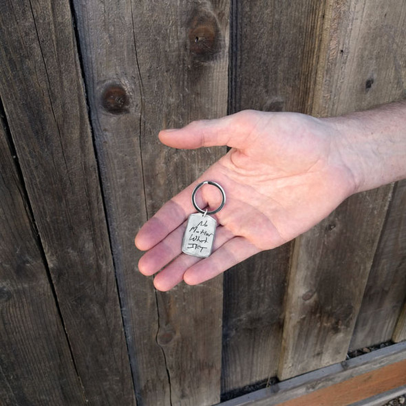 Military tag handwritten fine pewter key chain, shown in a hand