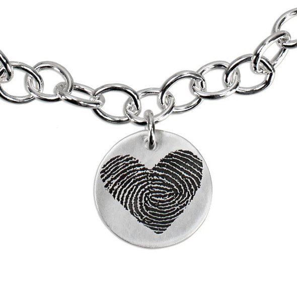 Close up of custom silver fingerprint charm bracelet