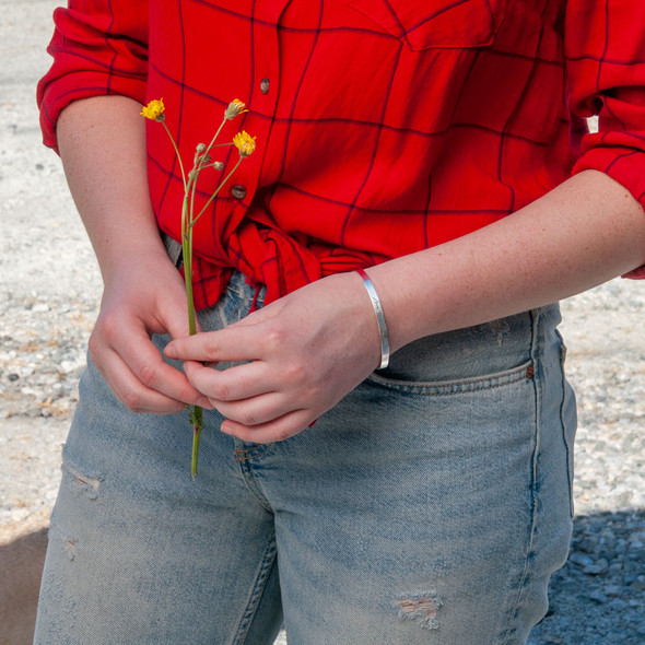 Sterling silver handwriting cuff bracelet with clasp, shown on a model