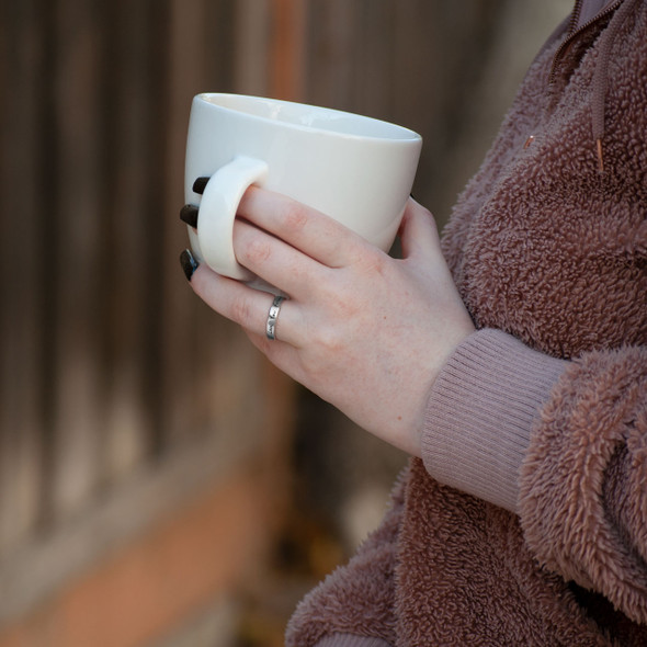 Model wearing custom Stackable Handwriting Ring, holding a cup of coffee