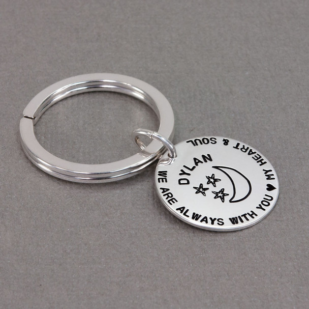 Custom hand stamped silver key chain for kid, personalized with parents' note, shown from the side