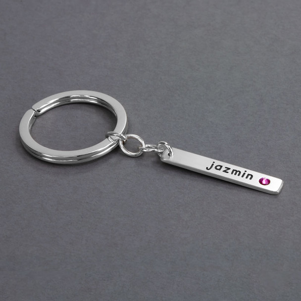 Side view of custom silver Your Saying Key Ring, personalized with daughter's name "Jazmin" and with her pink birthstone embedded in a silver bar