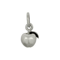 Tiny sterling silver apple charm for teachers, shown close up on white