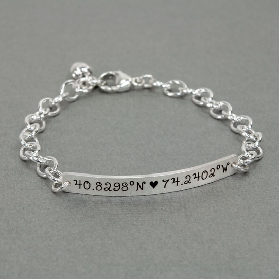 Silver personalized hand stamped coordinates bracelet, with latitude and longitude, shown on white