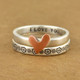 Silver flower ring stacked with our copper heart ring