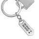 Sterling silver Hand stamped coordinates keychain on white background shown with key