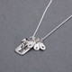 Side view of custom fine silver Family Tree necklace, personalized with hand stamped kids' initials, hung with pearl charm