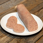 Leberwurst (Liverwurst) - 14oz, sliced and whole liverwurst sausage on a white plate, served on a wooden table.