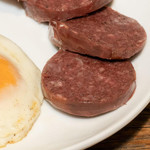 Blood Sausage - 14 oz, sliced blood sausage served on a white plate with a fried egg, ready for breakfast or brunch.