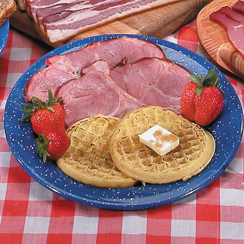 Sugar Cured Hickory Smoked Cottage Bacon - 1lb Package, sliced bacon served with strawberries, waffle, and butter on a blue speckled plate.