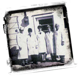 Bill Sloan and staff in white butcher coats, 1969