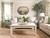 Grandmillennial living room in green and cream with jute rug, wood coffee table, and patterned curtains