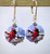 Powder blue lampworked "lentil" shaped earrings with cardinals