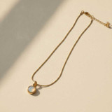 GOLD SNAKE CHAIN NECKLACE WITH ROUND MOTHER OF PEARL PENDANT