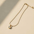 GOLD SNAKE CHAIN NECKLACE WITH ROUND MOTHER OF PEARL PENDANT