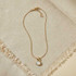 GOLD SNAKE CHAIN NECKLACE WITH ROUND MOTHER OF PEARL PENDANT