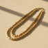 DOUBLE-STRAND MATTE GOLD HAMMERED BEAD STATEMENT NECKLACE