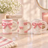 STONEWARE MUG WITH 3D BOW DESIGN
