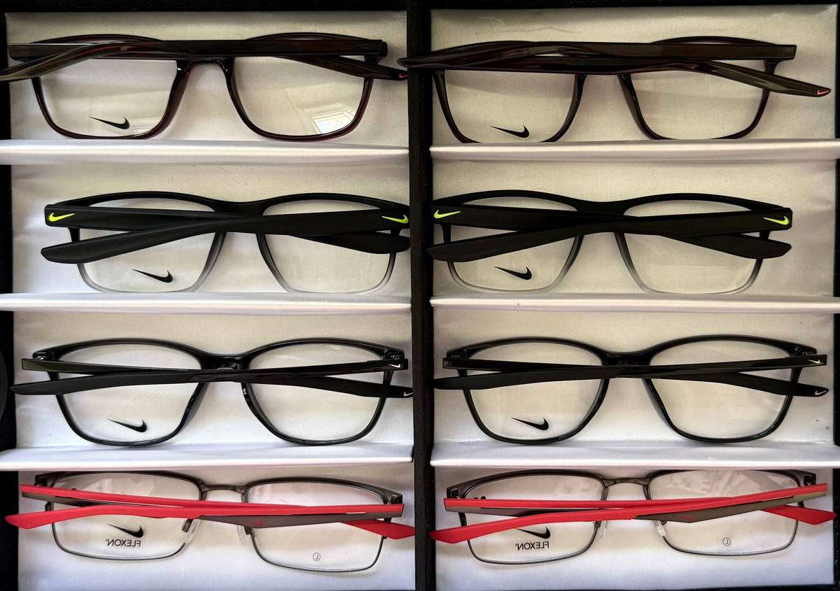 Eight Nike optical frames from Kit #9 arranged in two rows, showcasing rectangular and square silhouettes in satin gunmetal, matte black and university-red detailing. Eight Nike optical frames from Kit #9 arranged in two rows, showcasing rectangular and square silhouettes in satin gunmetal, matte black and university-red detailing.