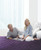 Man and woman on quantum energy pad on top of Biomat on top of queen bed
