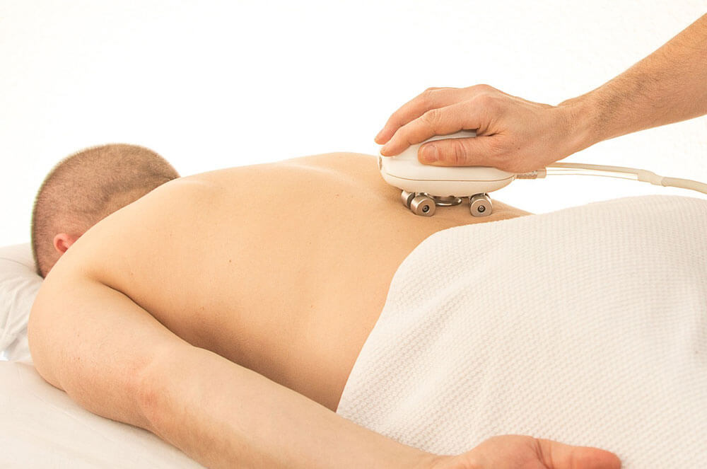 Man getting massage on table for back pain