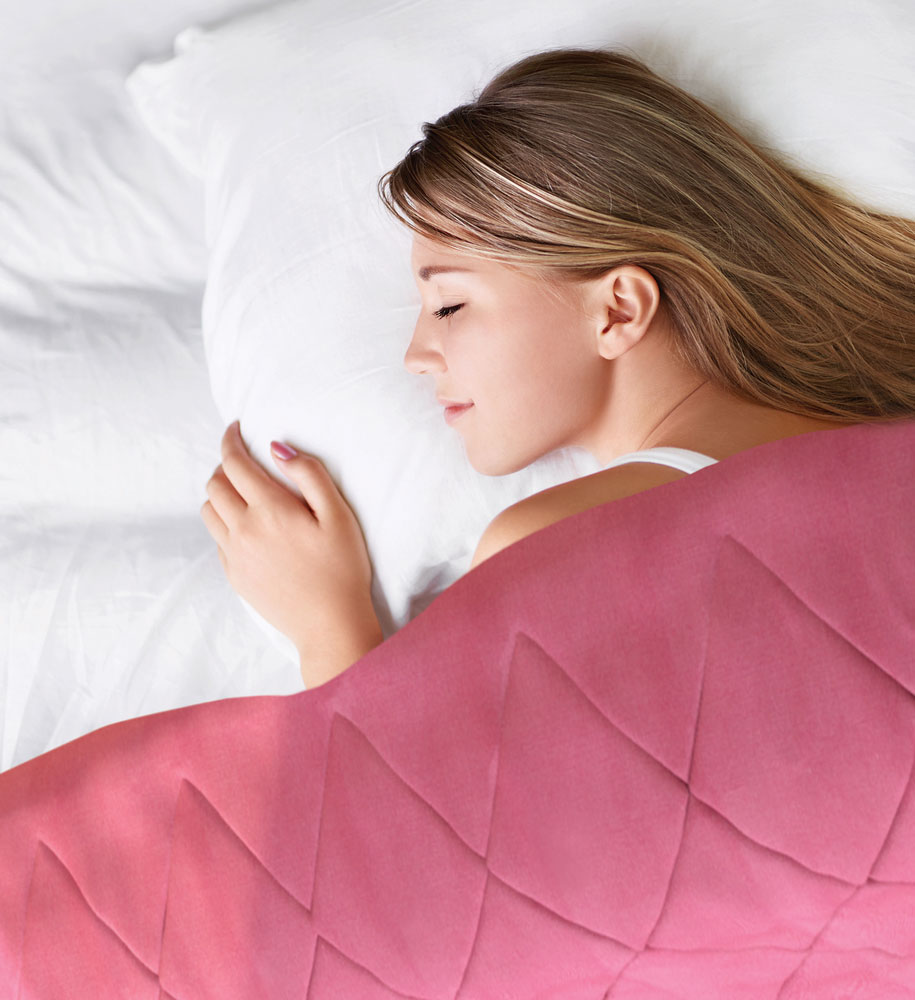 Woman layer down on bed covered with Bamboo Silk Comforter