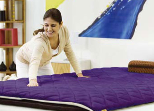 Woman placing Quantum Energy Pad on Biomat