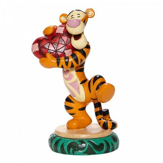 Disney traditions Tigger from Winnie the Pooh hugs a heart figurine