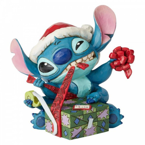 Disney Traditions Stitch, Alien 626 from Lilo & Stitch  in a Santa hat wrapping a present figurine