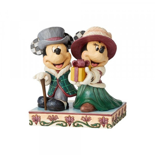 Disney Traditions Mickey and Minnie dressed in Victorian holiday outfits, Minnie holds a present Figurine