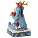 Disney Traditions Eeyore from Winnie the Pooh wears antlers and carries a poinsettia figurine