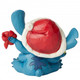 Disney Traditions Stitch , Alien 626 from Lilo & Stitch  in a Santa hat wrapping a present figurine