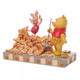 Disney Traditions Winnie the Pooh rakes a yard-full of leaves into a giant pile while Piglet prepares to leap into it figurine