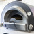 Hybrid Wood and gas fired pizza oven angled front.