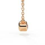 Side view of the rubover setting with a brilliant-cut diamond on a rose gold chain.