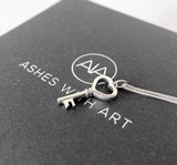 key ashes pendant on box