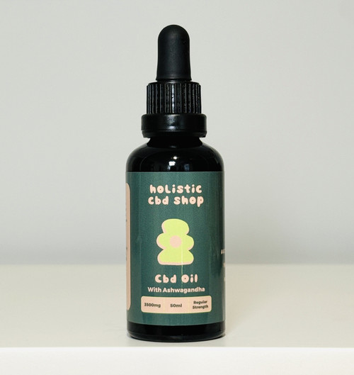 The image features a sleek Amber Glass 50ml CBD Oil bottle, set against a clean, white background. The bottle is filled with a rich, golden oil, and is adorned with a dark green label that highlights its key ingredients: Ashwagandha oil and Cannabis Indica. The dark green label adds a touch of sophistication and natural elegance to the bottle, which conveys a sense of wellness and tranquility. The minimalist design and clarity of the white background emphasize the purity and high quality of this holistic Australia CBD oil blend, perfect for promoting relaxation and overall well-being.