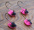 Underside view of four Pink and Black Nose Erie Short Shank Jigs
